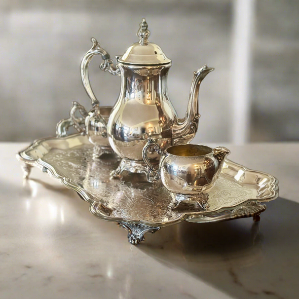 Silver-plated tea set with pot, sugar and cream dispensers and serving tray
